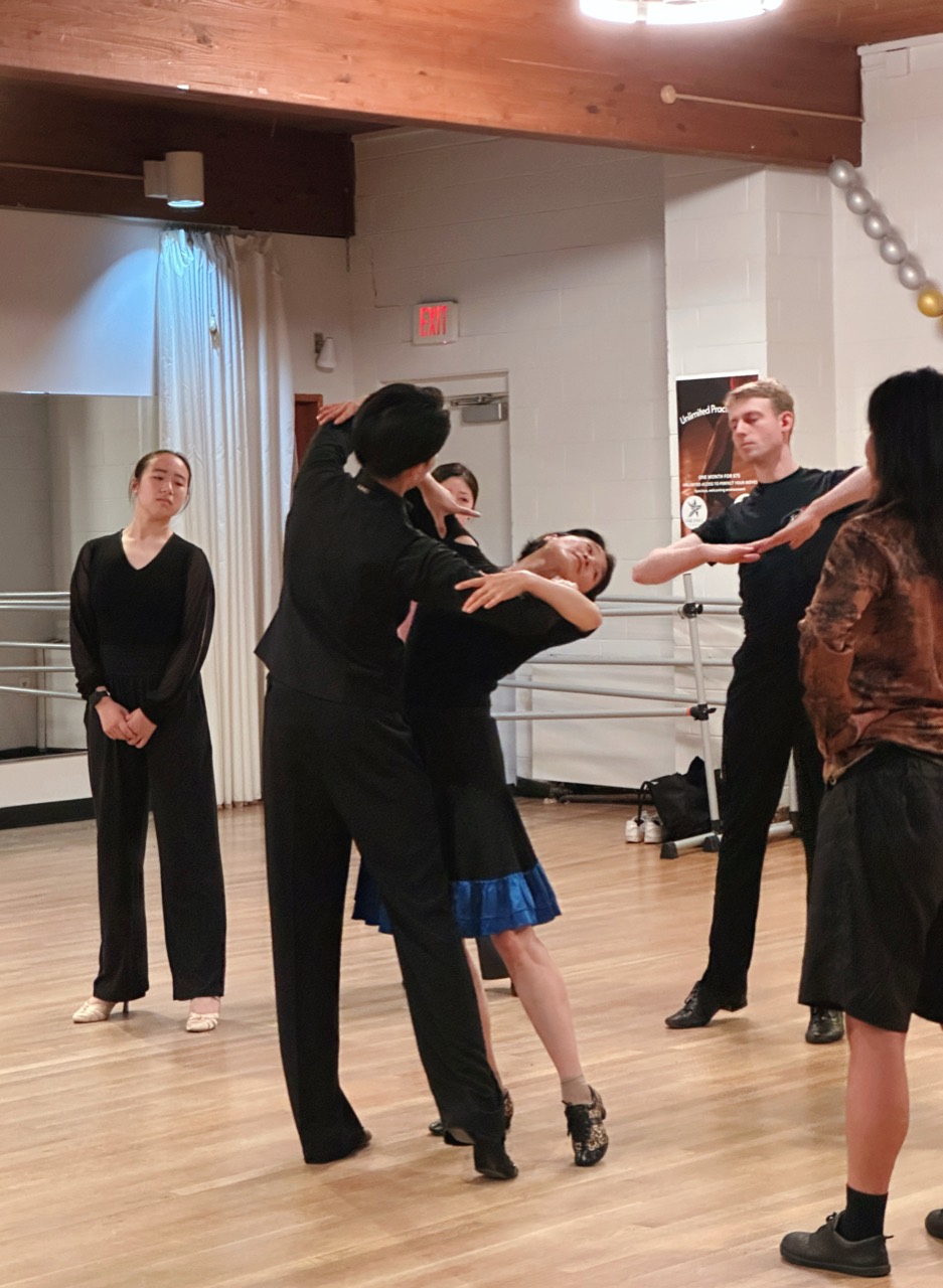 Ballroom students practicing partner technique in class